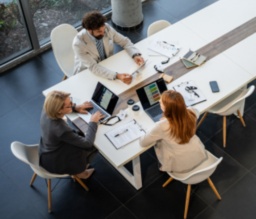 Three businesspeople having a meeting at table.